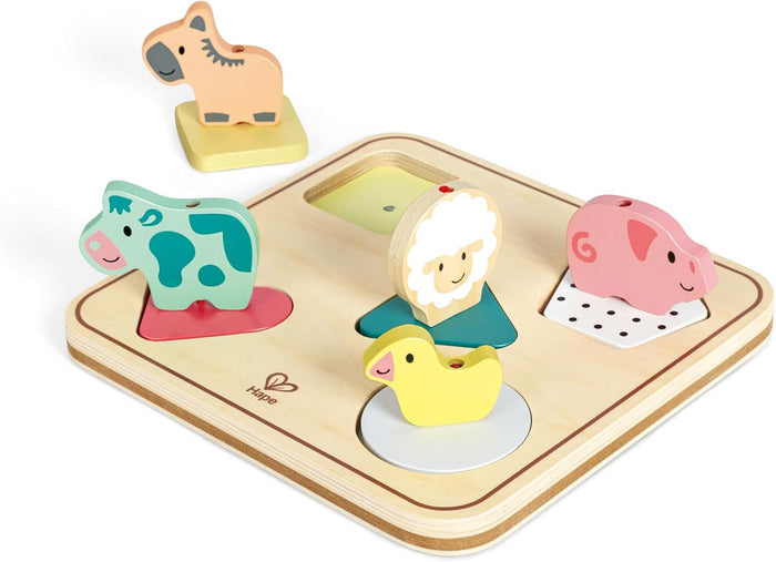 Wooden animal figures on colored shape bases fitting into a light-wood sorting tray with a horse figure nearby.