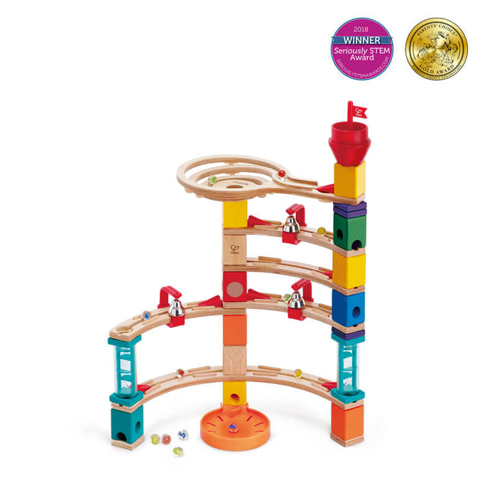 Multi-colored wooden marble run with curved tracks, bells, and a red flag funnel topper.