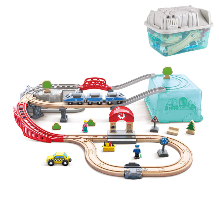 Multi-level wooden train set with blue train, red bridge, and taxi next to its teal storage bucket and grey lid.