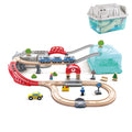Multi-level wooden train set with blue train, red bridge, and taxi next to its teal storage bucket and grey lid.
