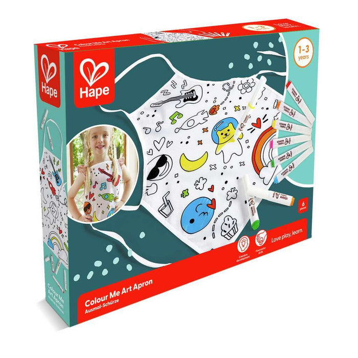 Teal and red Hape box showing a white apron with black line drawings, six fabric markers, and a girl wearing the apron.