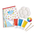 Art set with red, yellow, and blue paint tubes, brushes, flower palette, color wheel, and patterned paper book.