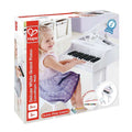 Packaging for a white toy grand piano with stool. Image shows a girl playing the 30-key instrument with music book.