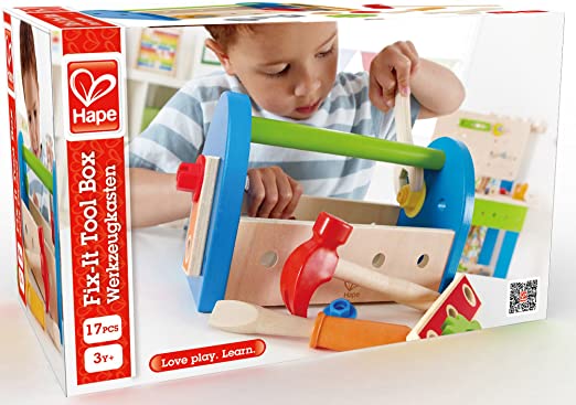 Hape toy packaging shows a child with a blue and wood tool kit featuring a red hammer, green handle, and wooden wrench.