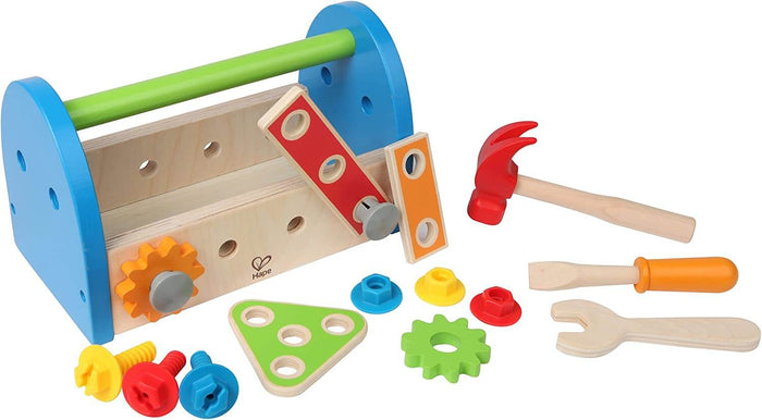 Wooden toy toolbox with blue ends, green handle, hammer, screwdriver, wrench, and colorful nuts, bolts, and gears.