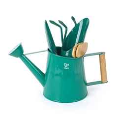 Teal green toy watering can holding a matching trowel and rake set with light-colored wooden handles.