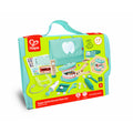 Hape dental kit in a teal bag with wooden tools, a teeth model, and charts on a lime green and red box.