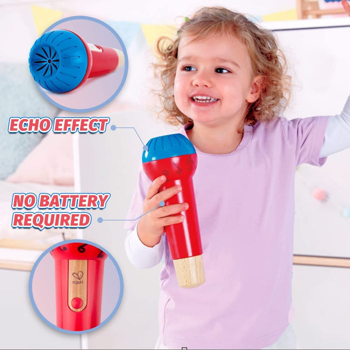 Child holds a red and blue toy microphone with a wooden base. Highlights echo effect and no batteries required.