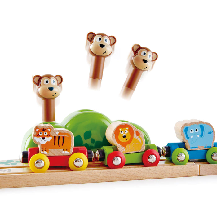 Wooden train with tiger, lion, and elephant cars. Three monkey pegs pop up from a green hill behind the track.