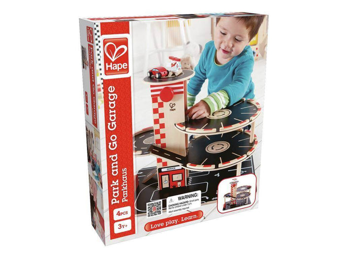 White and red box for a multi-level wooden toy garage with three black spiral ramps and a child playing on the front.
