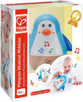 Blue and white penguin toy with wooden base and musical notes in packaging showing a baby playing.