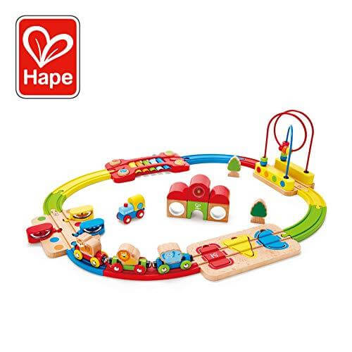 Colorful wooden toy train set with animal cars on an oval track featuring a bead maze, xylophone, and shape sorter.