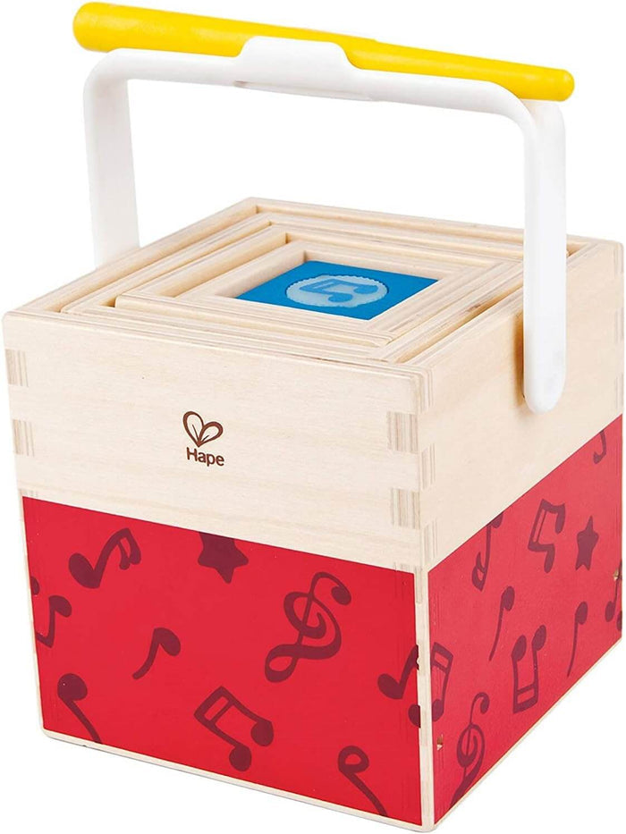 Nested light wood cubes with red musical note sides and a white and yellow plastic carrying handle.