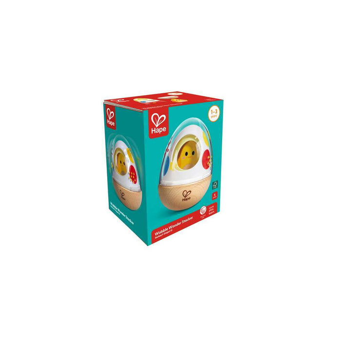 Teal and red box showing an egg-shaped toy with a wooden base and yellow chick inside for toddlers ages 1-3.