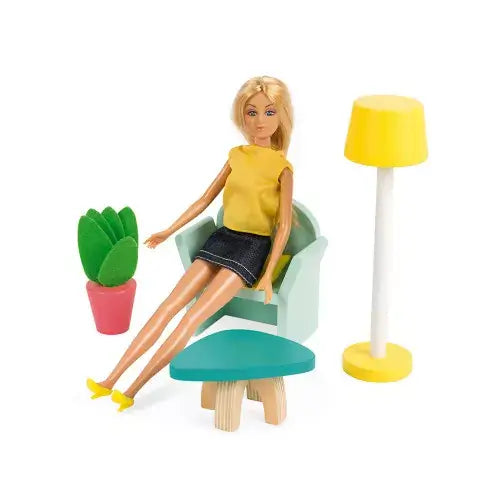 Blonde doll in yellow top sits in a mint armchair with a teal coffee table, yellow floor lamp, and potted plant.