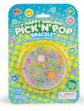 DIY bracelet kit in a blue and yellow polka dot blister pack with pastel smiley face beads inside a round window.