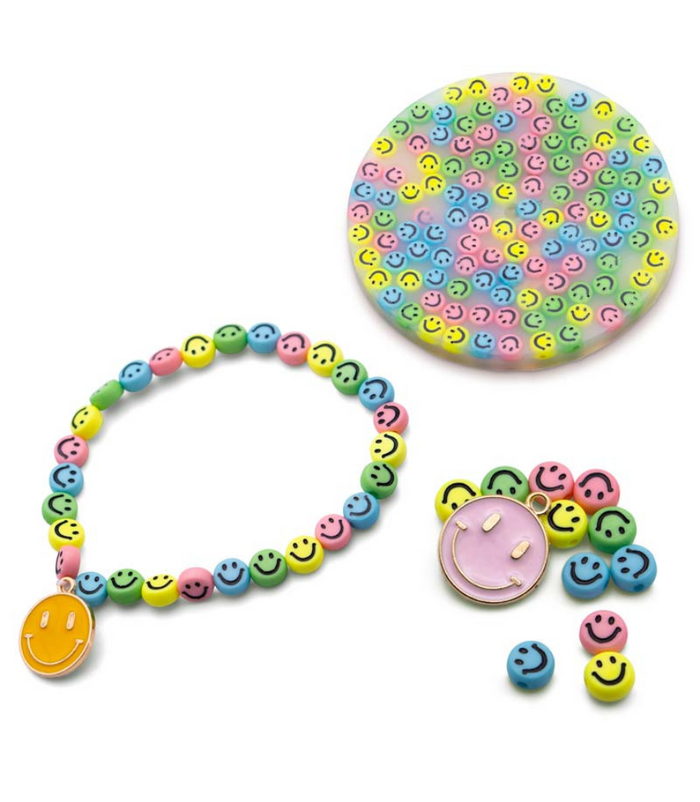 Colorful smiley face bead bracelet with yellow charm, loose beads, and a circular tray filled with matching beads.