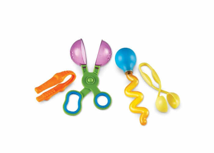 Four colorful plastic tools: orange tweezers, green and purple scoopers, a blue bulb dropper, and yellow scooper tongs.