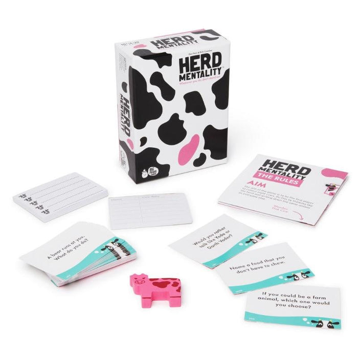 Cow print game box with rulebook, question cards, score pads, and a pink cow figurine on a white background.