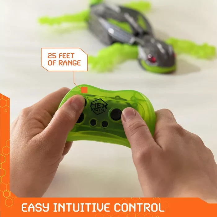 Hands hold a green remote for a robotic gecko toy with text highlighting 25-foot range and easy intuitive control.