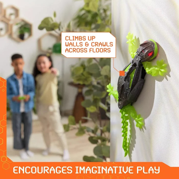 Black and neon green robotic gecko toy with glowing red eyes climbing up a vertical white wall.