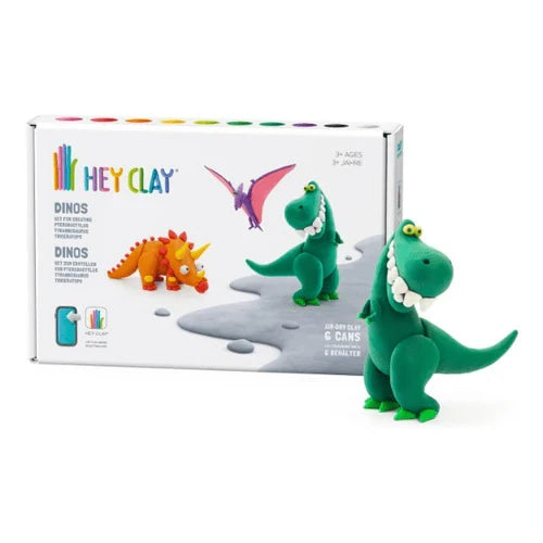 White box with colorful clay dinosaur models next to a finished green T-Rex figure with a wide, toothy grin.