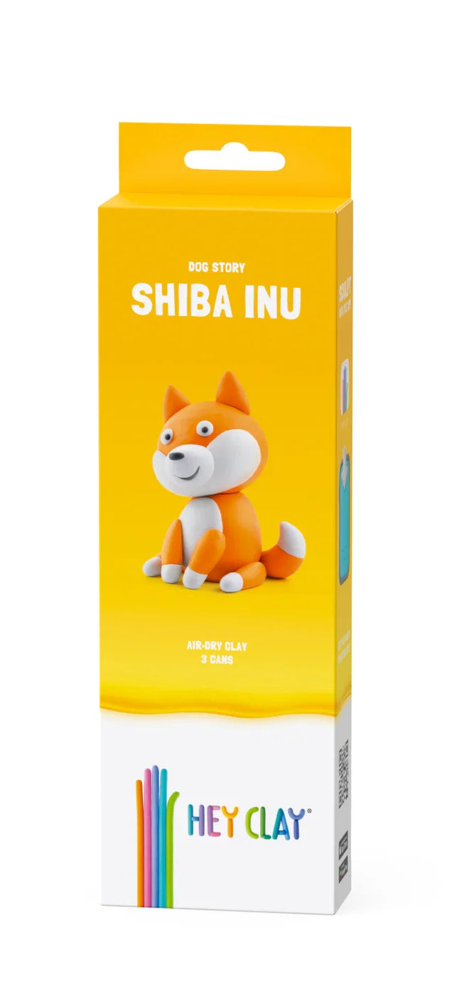 Yellow box featuring an orange and white clay Shiba Inu model, air-dry clay text, and a colorful hand-shaped logo.