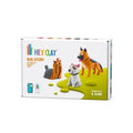 White box showing three clay dog models: a Yorkie, a white bull terrier, and a German Shepherd on a lime green surface.