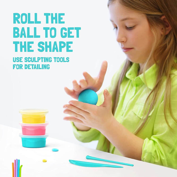 Girl rolling a blue clay ball next to stacked yellow, pink, and teal clay containers and two sculpting tools.