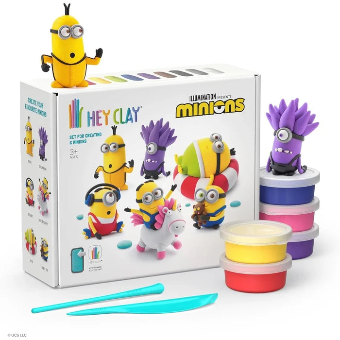 Minions clay kit with a white box, yellow and purple figures, blue tools, and colorful stacked clay containers.