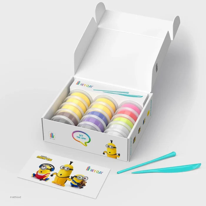 Open box of 15 colorful clay cans, two blue sculpting tools, and a card featuring Minion characters.