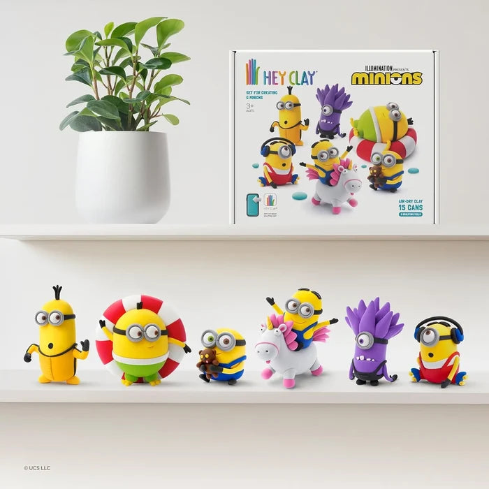 Hey Clay Minions kit box and six clay figures, including a purple minion and one on a unicorn, on white shelves.