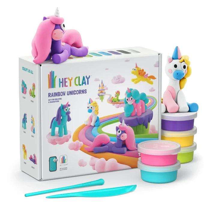 Hey Clay Unicorns kit with white box, bright clay cans, blue tools, and colorful sculpted unicorn figures.