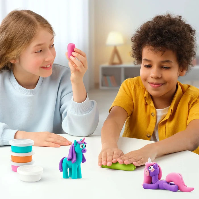 Children sculpting teal and purple unicorns with modeling clay from colorful tubs on a white table.
