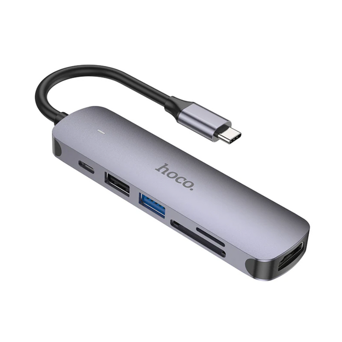 Techplus Hoco PD 100W USB-C 6-in-1 adapter hub with multiple ports for charging and data transfer, shown connected to devices.