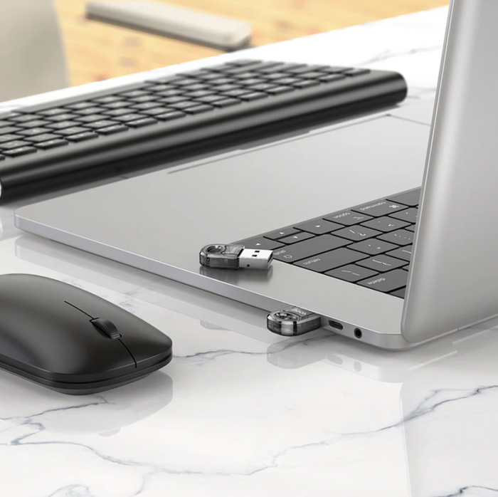 Techplus Hoco USB Bluetooth receiver adaptor wireless dongle connected to a computer for wireless audio streaming.