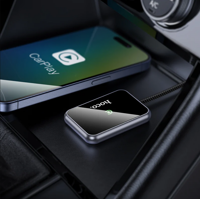 TechPlus Hoco Wireless CarPlay Adapter USB-A to USB-C converter connected to a vehicle's dashboard.
