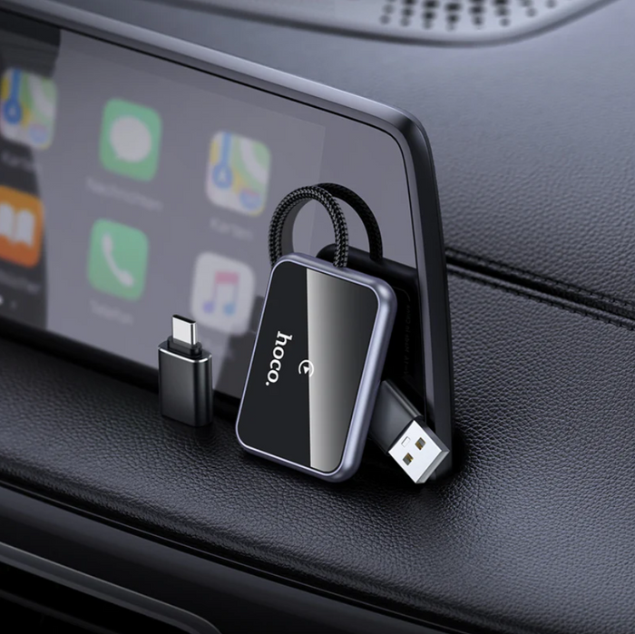 TechPlus Hoco Wireless CarPlay Adapter USB-A to USB-C converter connected to a car dashboard for seamless smartphone integration.