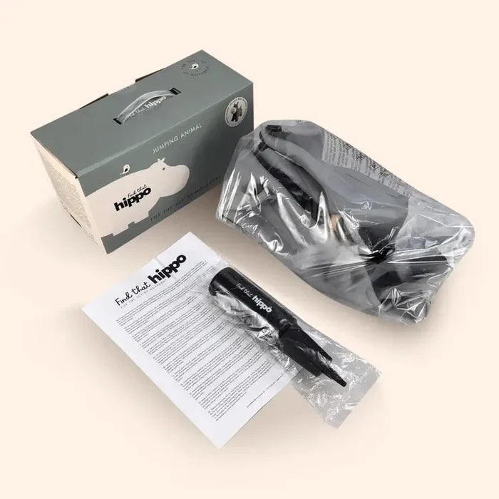 Gray box for a jumping toy next to a deflated gray hippo, black hand pump, and instruction manual.