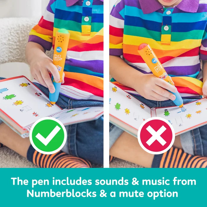 Child using orange interactive pen on Numberblocks book; green light for correct answer, red light for incorrect.