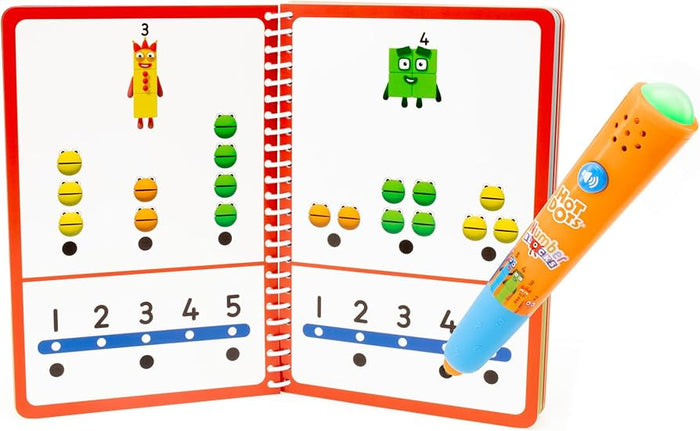 Orange interactive pen touching a dot in a spiral-bound Numberblocks activity book with colorful block characters.