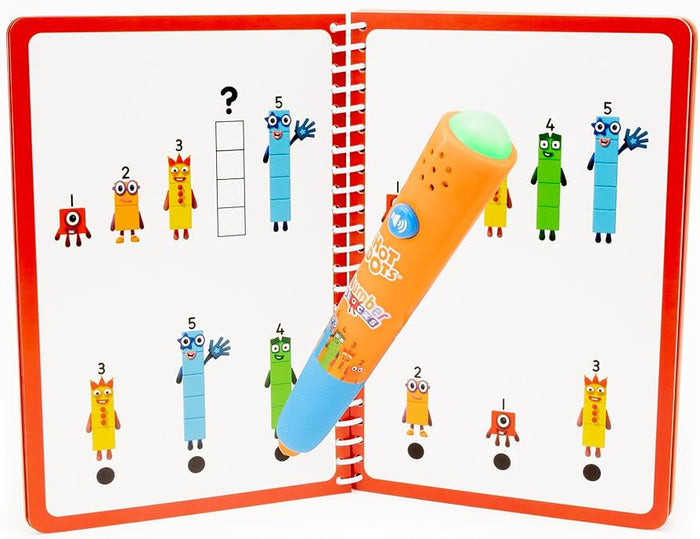 Orange interactive pen with a glowing green tip touching a black answer dot in a Numberblocks activity book.