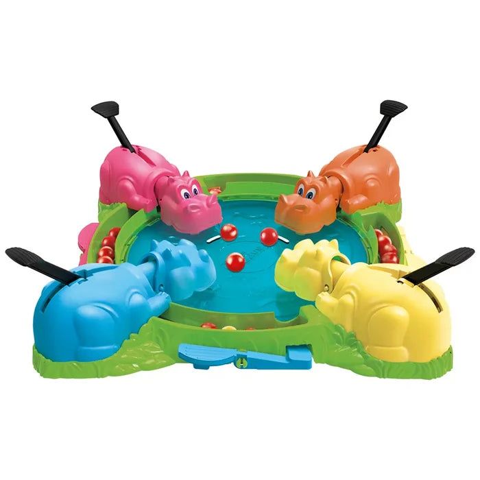 Four colorful toy hippos in pink, orange, blue, and yellow surrounding a green pond with small red marbles.