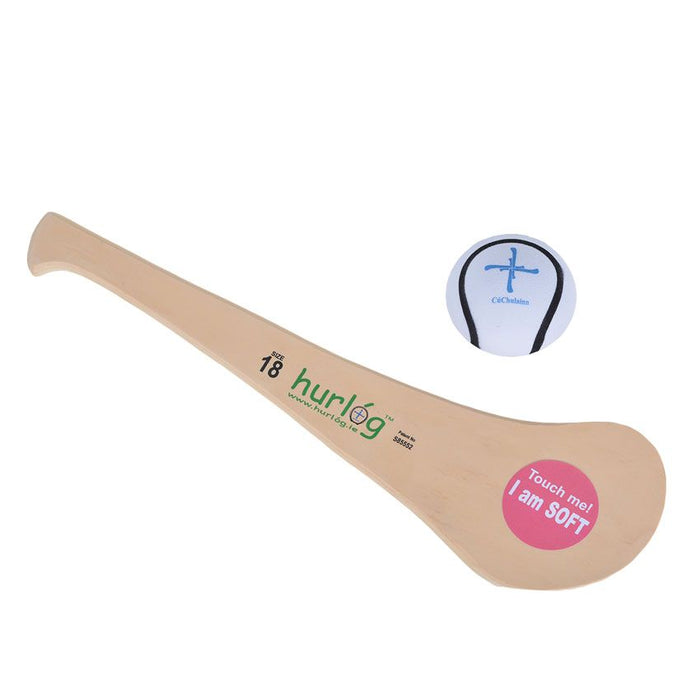 Tan foam hurling stick with a pink soft-touch sticker and matching white soft ball with blue cross markings.