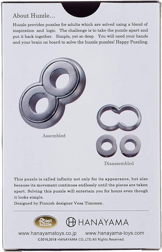 Back of white puzzle box showing a silver metallic figure-eight shape in assembled and disassembled states.