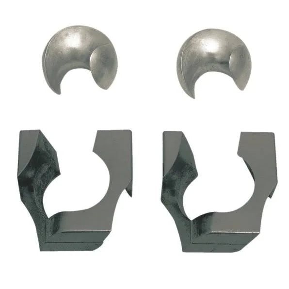 Four metal puzzle pieces: two silver spherical segments and two dark grey angular interlocking frames.