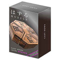 Bronze hexagonal metal puzzle with compass letters on a dark grey box featuring a pink six-star difficulty rating.