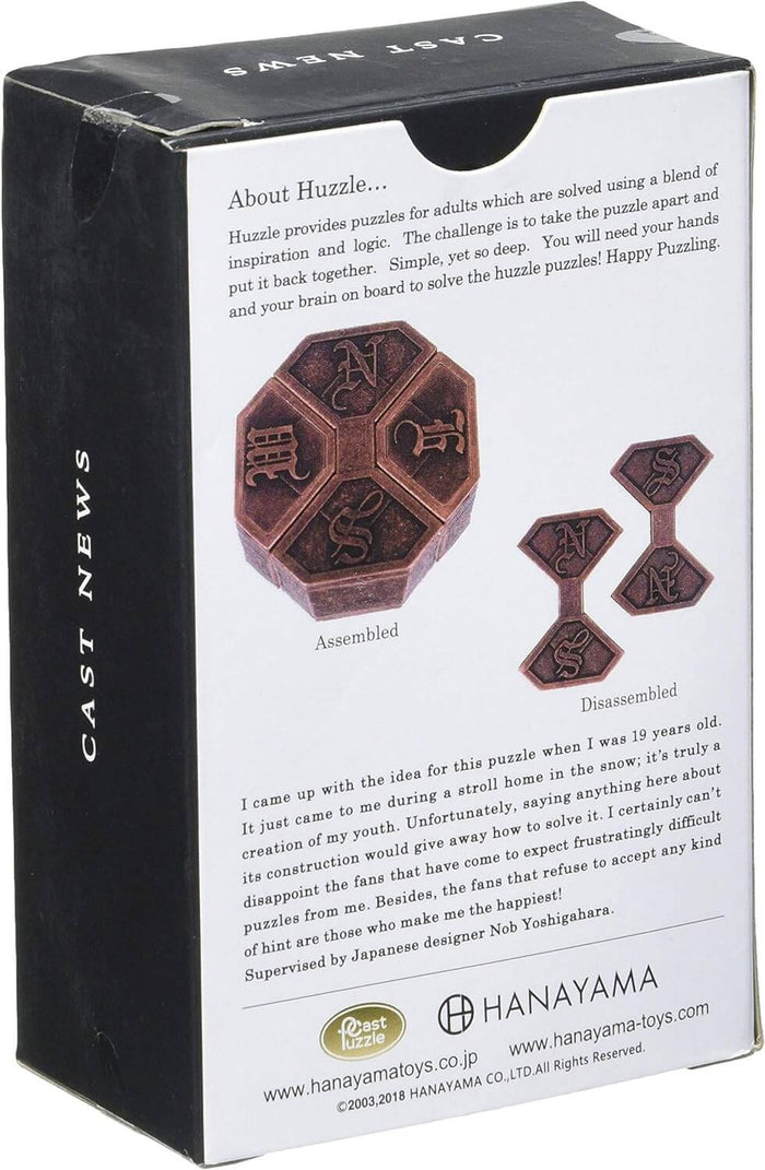 Dark bronze metal hexagonal puzzle with N, E, W, S letters, shown assembled and disassembled on its retail box.