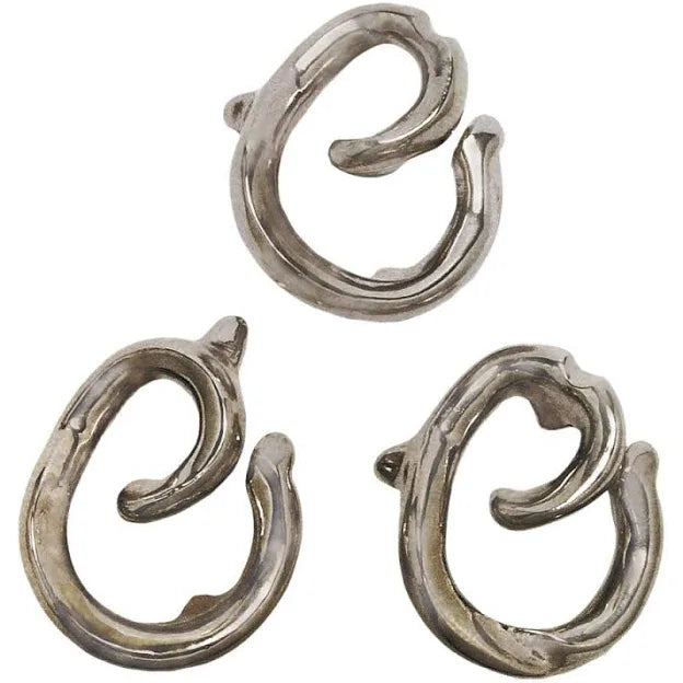 Three silver cast metal puzzle pieces with swirling hook shapes arranged on a white background.