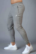 Light grey Fuaark Nz Identity Nylon Joggers with a relaxed fit and adjustable waistband, made of lightweight nylon fabric.